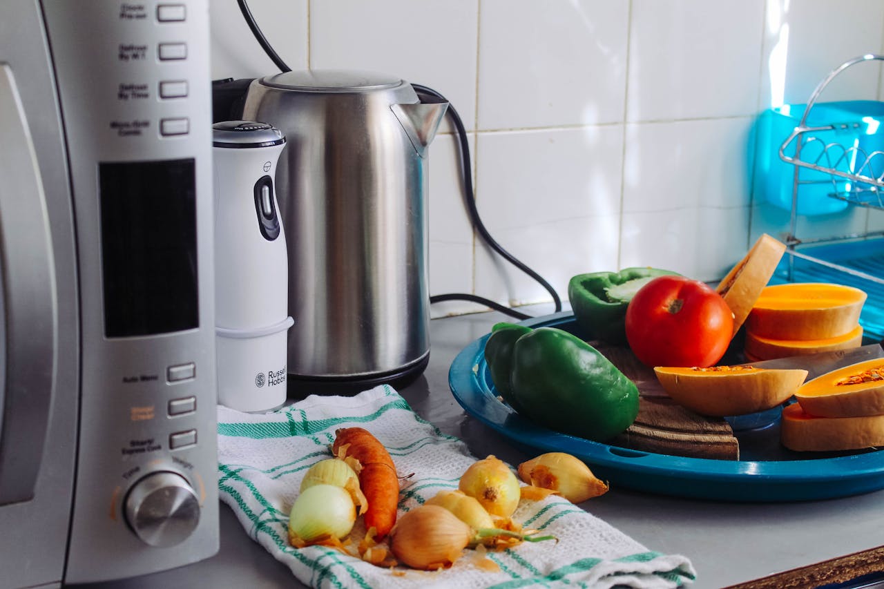 project-01-a A modern home kitchen counter displaying fresh vegetables and appliances, ideal for healthy cooking.