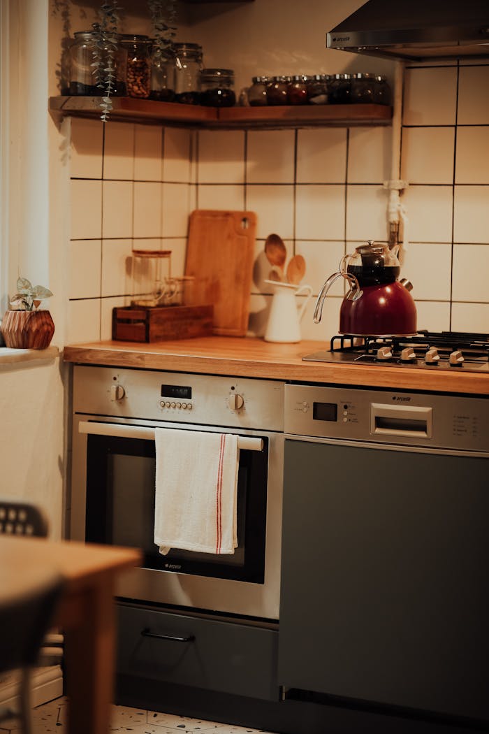services-07 Stylish kitchen interior featuring modern oven, stove, and wooden countertops.