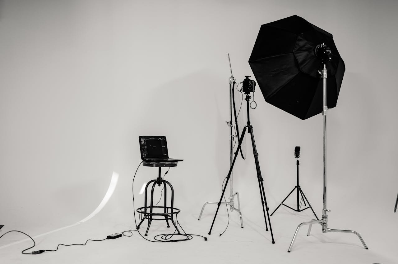 services-08 A black and white photo of a well-equipped photography studio with lighting equipment and tripods.