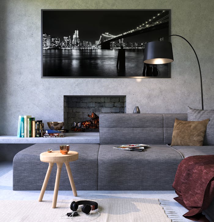 project-02-d Modern gray living room featuring a fireplace and cityscape artwork, creating a cozy ambiance.