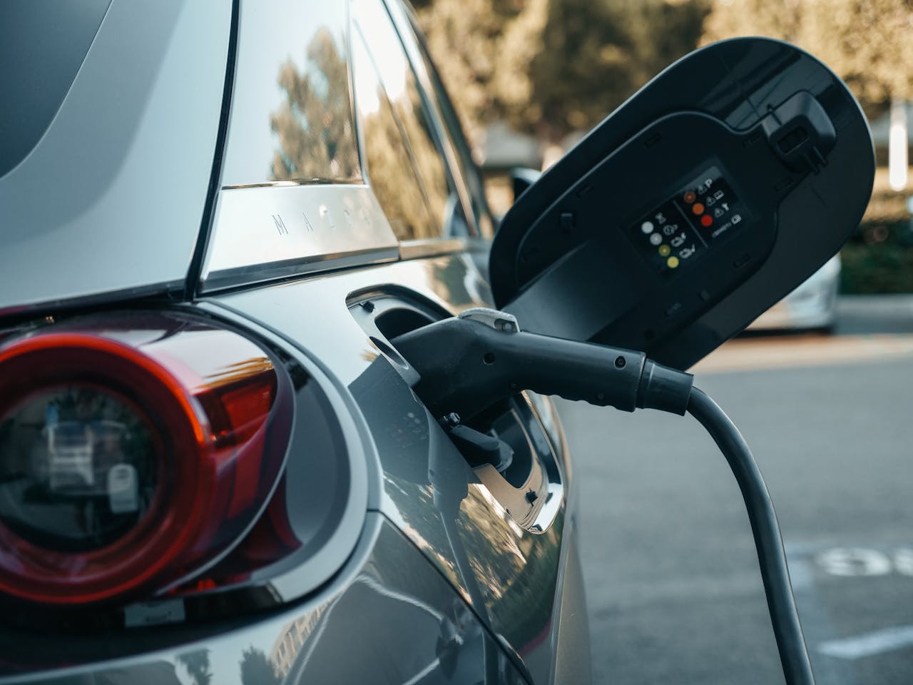 about-002 Close-up of an electric vehicle being charged, highlighting modern clean energy technology.